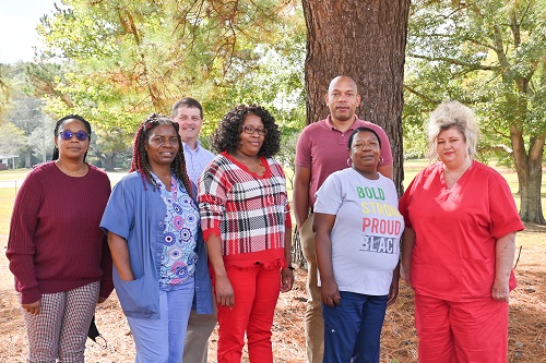 Congratulating the Winners are (back left to right) Kevin Polk, Dir. Of Programmatic Services; Eric Caples, Dir. Of Units; (front left to right) Margo Knighton, Assist. NHA; (Winners starting second on the front left to right) Katrina Wolverton, Barbara Miller, Stephanie Allen, and Betty Butler.