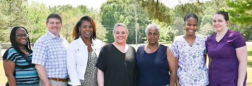 Congratulating the Winners (Left to Right) Margo Knighton, NHA asst.; Kevin Polk, Dir. Of Prog. Services; Georgette Powell, Comm. Home Dir.; Andrea Walters, Prog. Admin.; Winners are (Starting Beginning Fifth Left to Right) Evonne Rhodes, Donielle McGlaston, Taretta McAuley, and Curtis Trotter (not pictured).