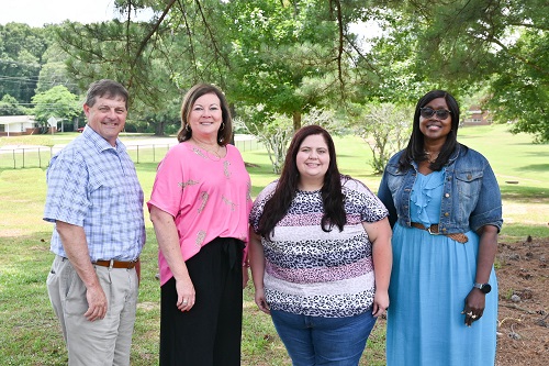 Congratulating the Winners (Left to Right): Kevin Polk, Dir. Of Prog. Services; Candy Maxey, Assist. Dir. Of ESS.; Winner (Third Left to Right): Lynda Collier; Congratulating the Winners (Fourth Left to Right): Rinsey McSwain, Agency Director of ESS; Other Winners: Carla Taylor, Lowelyn Bufkin, and Courtney Taylor (not pictured).