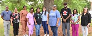 Larger Group Photo Caption: (Left to Right): (Administrators) Chris Phillips, NHA Assist. Pecan Grove Unit; Cathy Lindsey, Shift Superv. Coord.; (Winners) Courtney Taylor, Latasha Cooper, Monique Terrell, Christy Smith, Georgia Moffett, Andre McDonald, (Administrators) Tawanda Jones, NHA Assist. Hillside Unit; and Andrea Walters, NHA Paul D. Cotten, Sr. Unit.